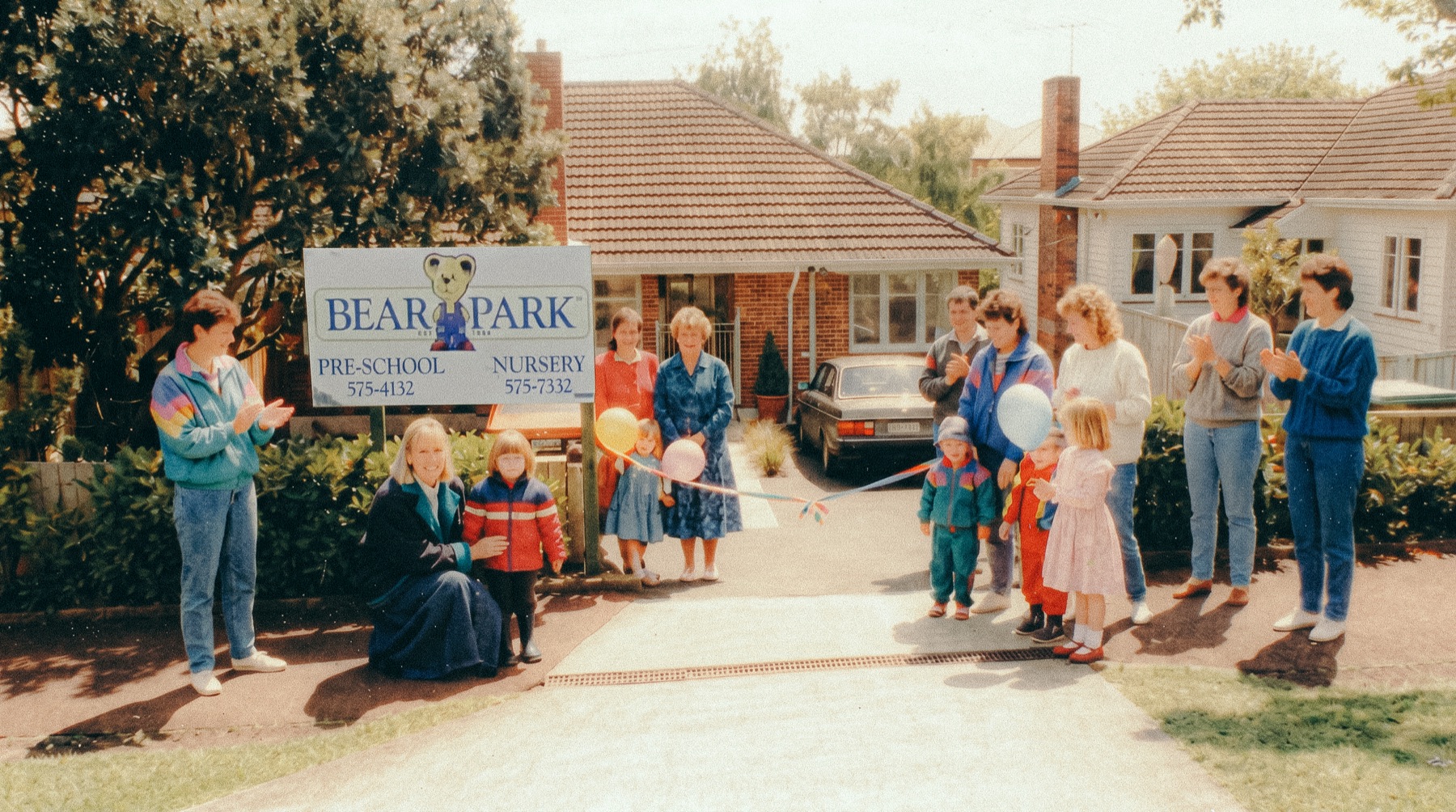 Opening day at the first Bear Park, St Heliers, 1986: Sue Stevely-Cole and families at the ribbon under the original Bear Park pre-school and nursery sign