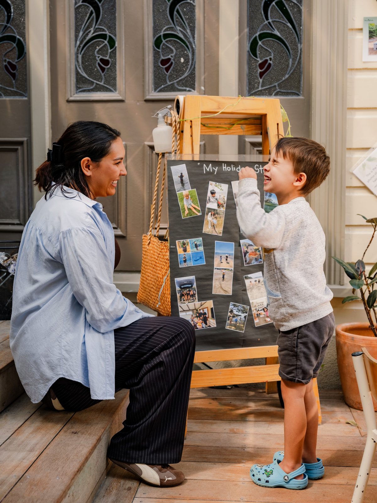 A child proudly presenting his work to a delighted teacher
